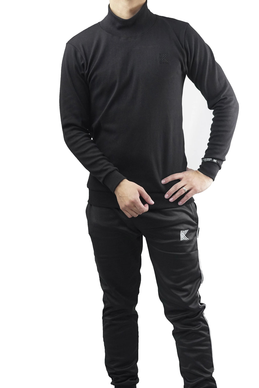 Person wearing a black long-sleeve top and pants with a brand logo on a white background