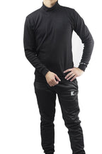 Person wearing a black long-sleeve top and pants with a brand logo on a white background