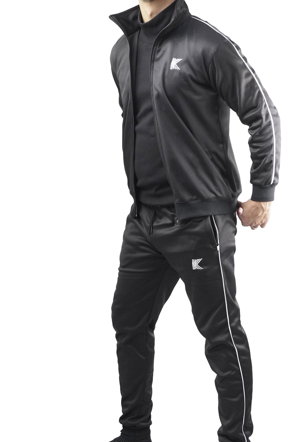 Person wearing a black tracksuit with white stripes and a brand logo on a white background