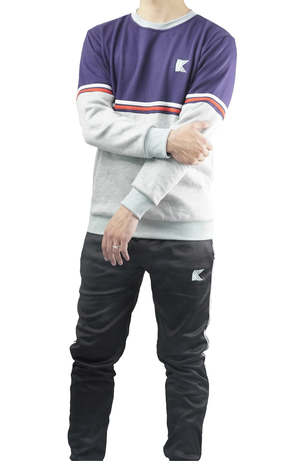 Person wearing a two-tone sweatshirt with a logo on a white background