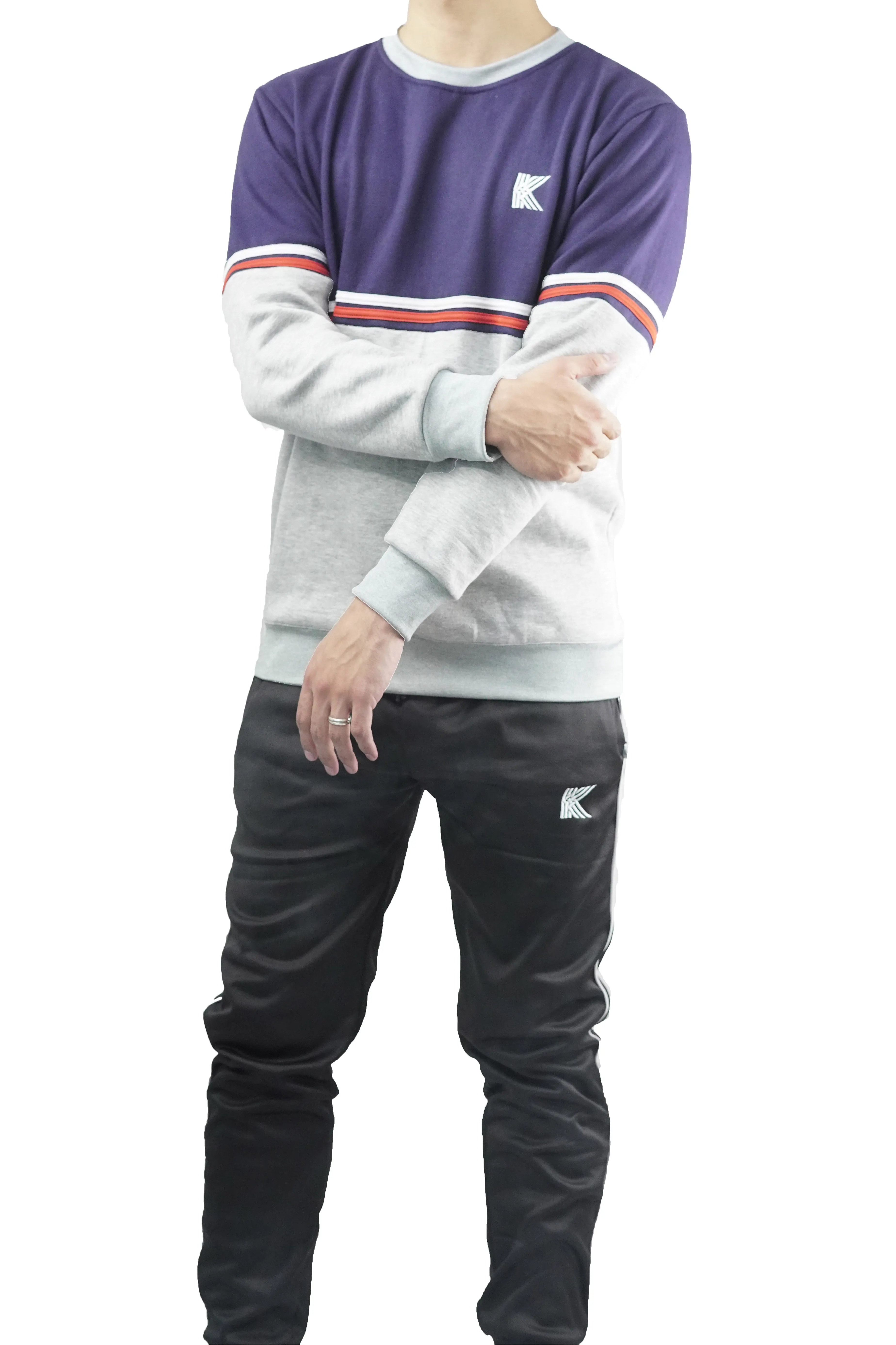 Person wearing a two-tone sweatshirt with a logo on a white background