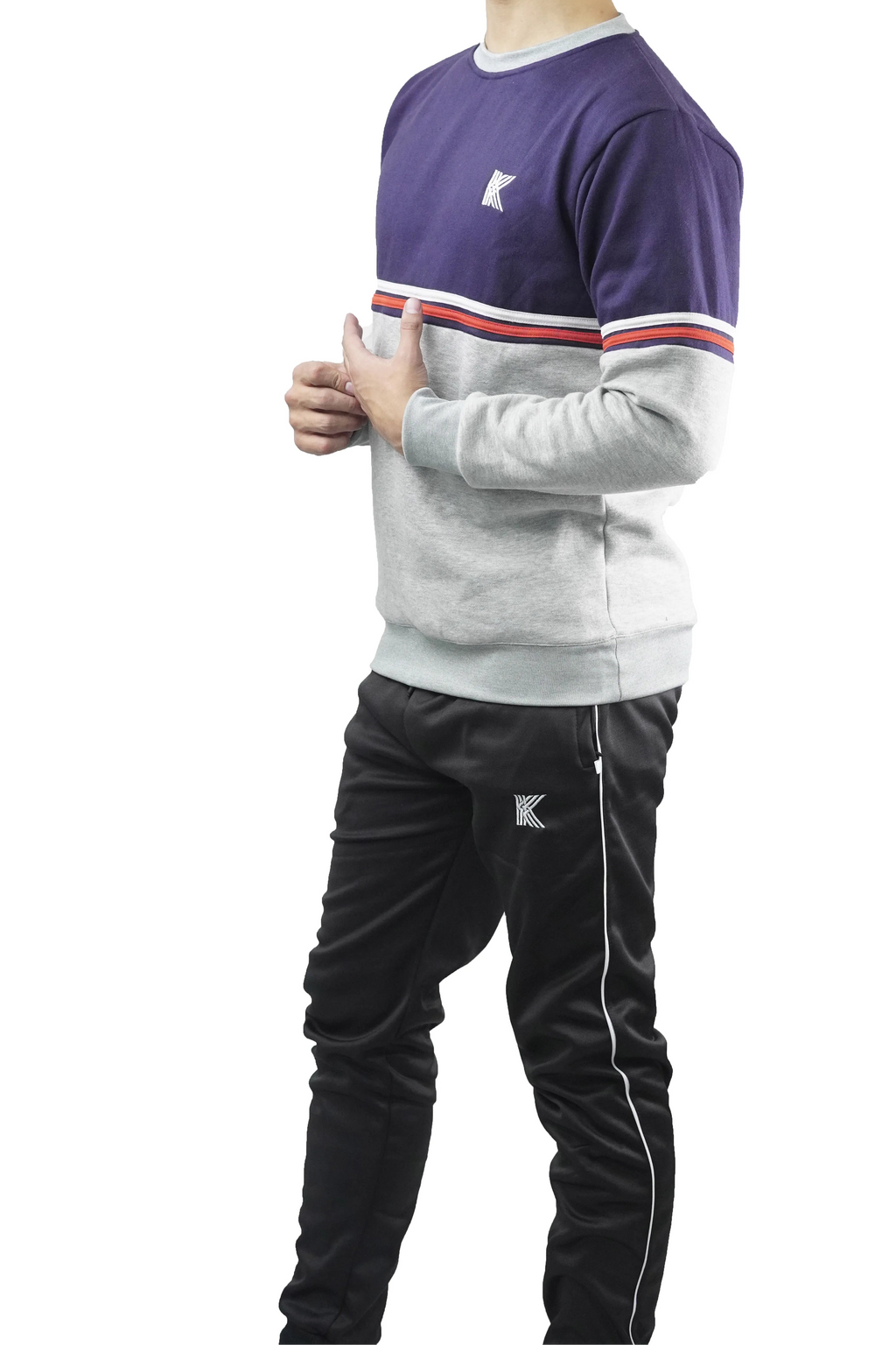 Person wearing a tracksuit with a brand logo on a white background