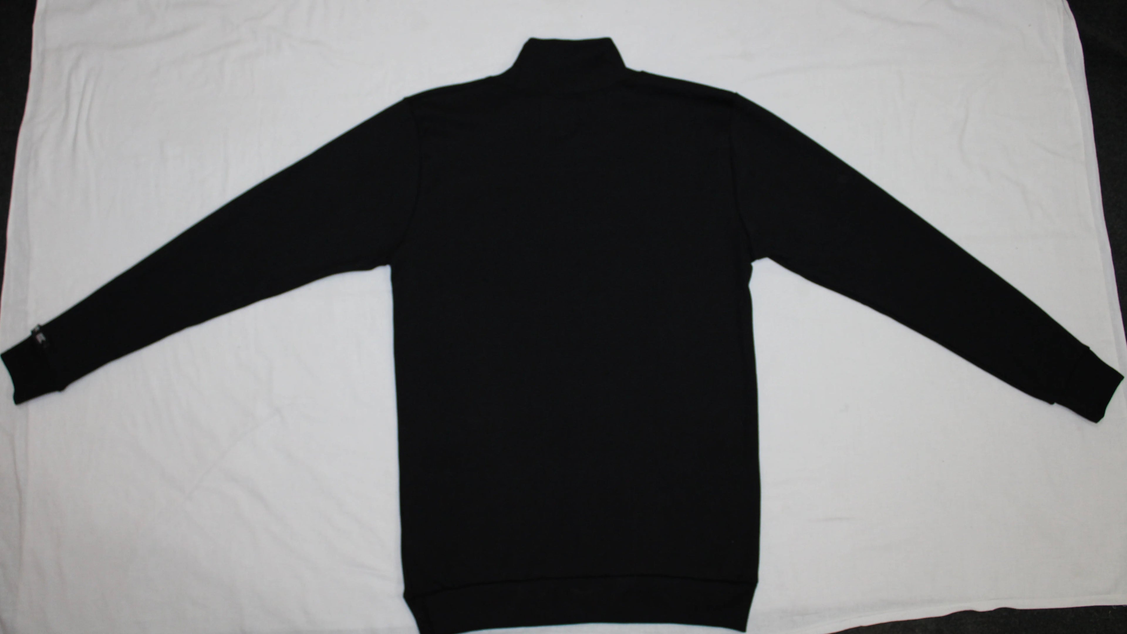 Black turtleneck sweater on a white background